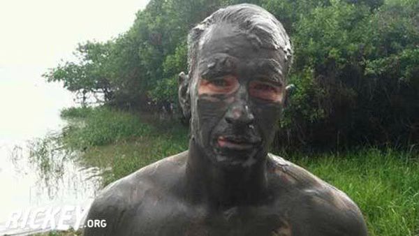 Anderson Cooper is shirtless and covered in mud