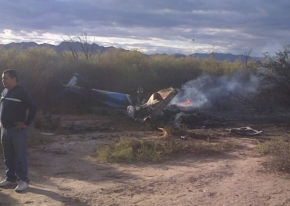 A man stands near one of two helicopters that crashed near Villa Castelli in the La Rioja province of Argentina on March 9, 2015