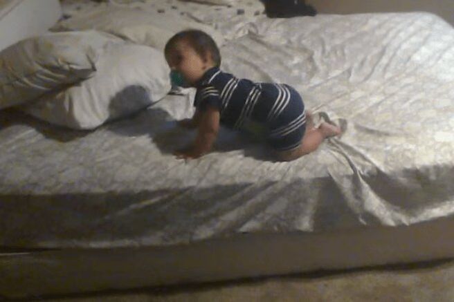 Genius Baby Adorably Climbs Off Bed In Cleverest Way Possible (VIDEO)