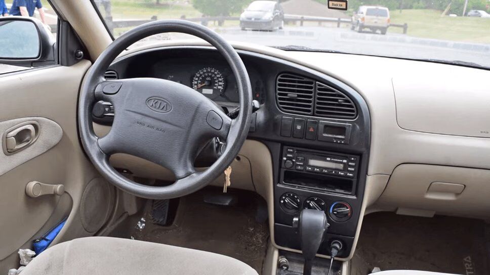Crazed Car Reviewer Examines Why Kia Spectras Are So Damn Bland (VIDEO)